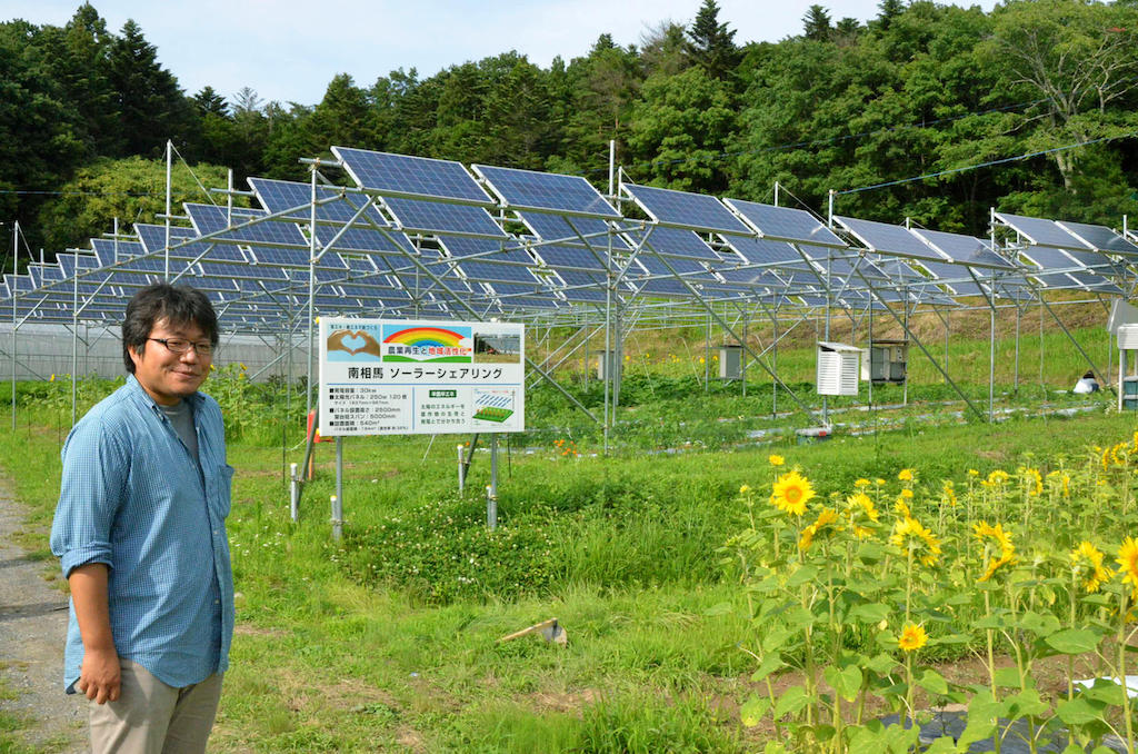 Sohei Takahashi, chief of the Eco-energy Minamisoma Research Institute, shows an experimental greenhouse run from solar power in Minamisoma, Fukushima Prefecture, on July 2 2015.